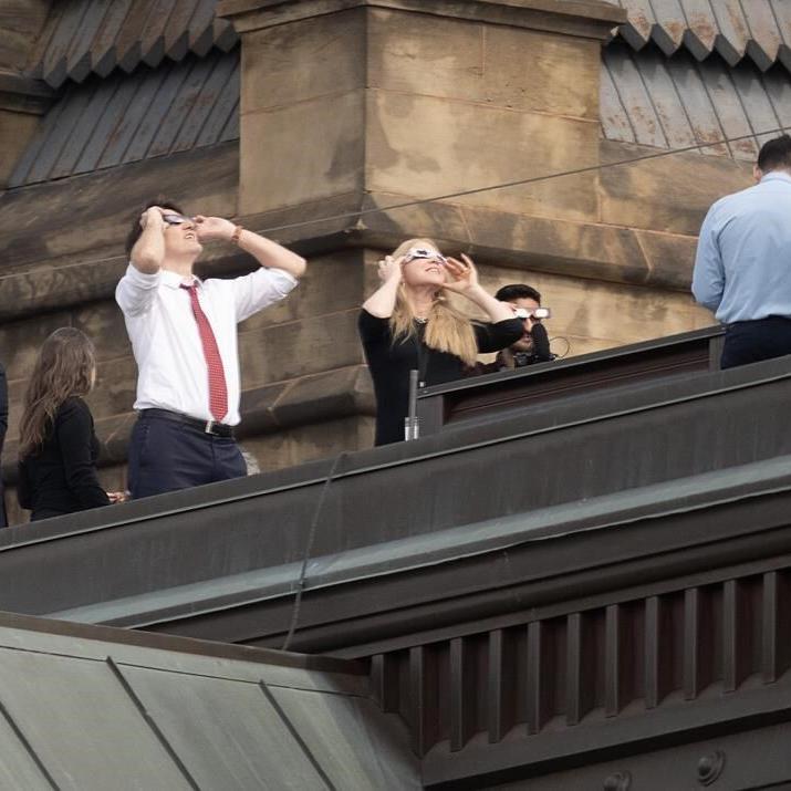 MPs clad in eclipse glasses stare at 'surreal' celestial event on Parliament Hill